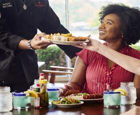 Happy people enjoying food at a Louisiana restaurant